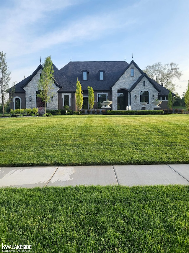 french country home with a front lawn