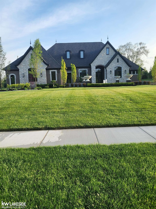 french country home featuring a front yard