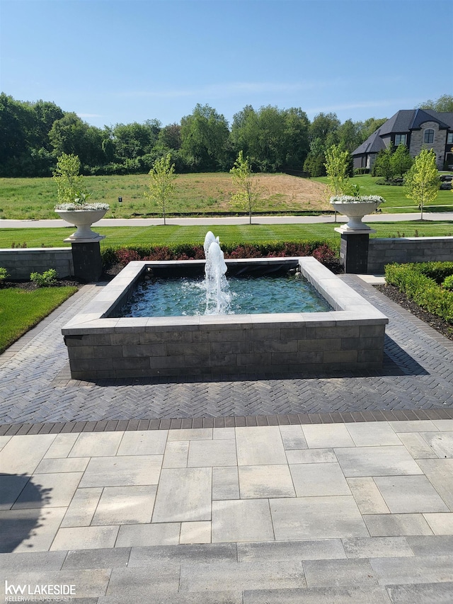 view of pool featuring a lawn