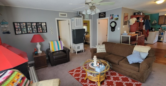 living room with ceiling fan and carpet flooring