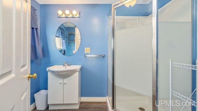 bathroom with walk in shower and vanity