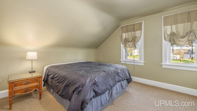 carpeted bedroom featuring lofted ceiling