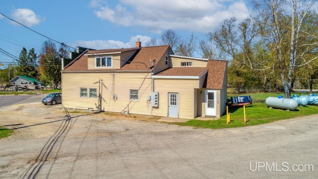 rear view of house with a yard