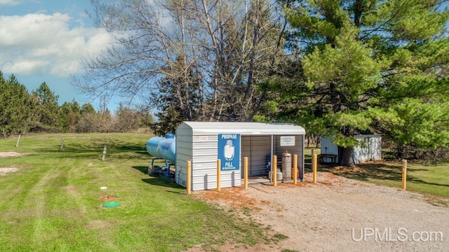 view of outdoor structure featuring a lawn