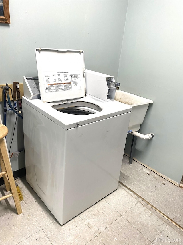 clothes washing area featuring light tile flooring and washer / clothes dryer