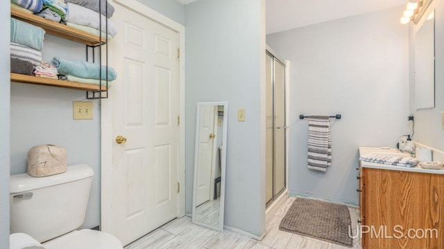 bathroom with walk in shower, tile flooring, vanity, and toilet