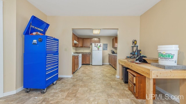 kitchen with white appliances and light tile floors