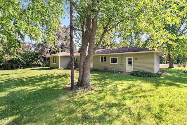 rear view of house with a lawn