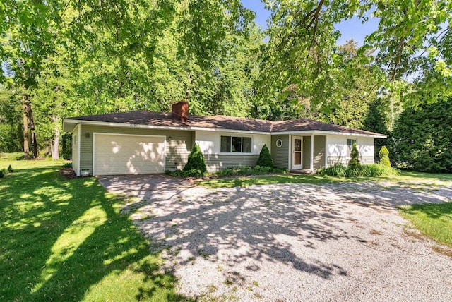 ranch-style house with a garage and a front lawn