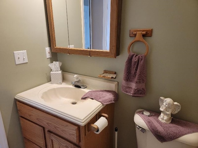 bathroom with large vanity and toilet