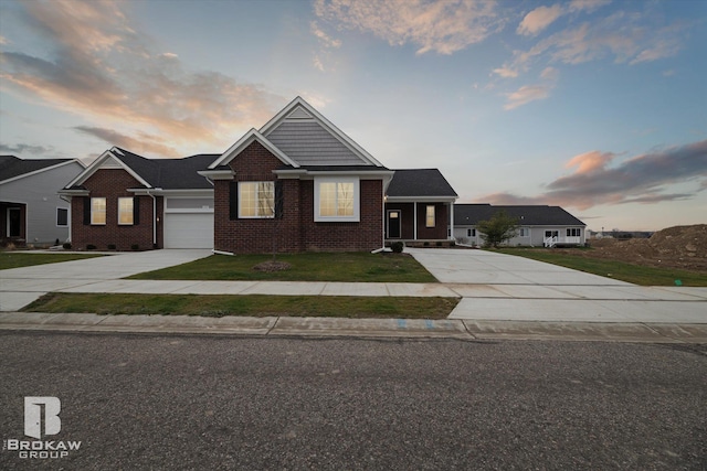 view of front of home with a garage and a yard