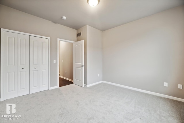 unfurnished bedroom featuring a closet and carpet