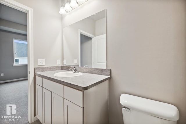 bathroom featuring vanity and toilet