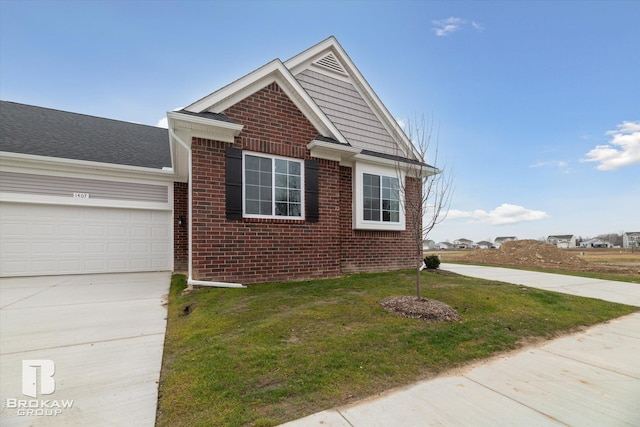 view of front of house with a front yard and a garage