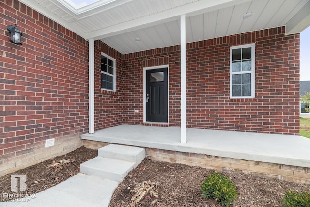 entrance to property featuring a porch