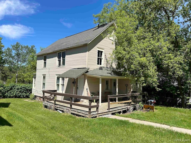 view of front of house featuring a deck and a front lawn