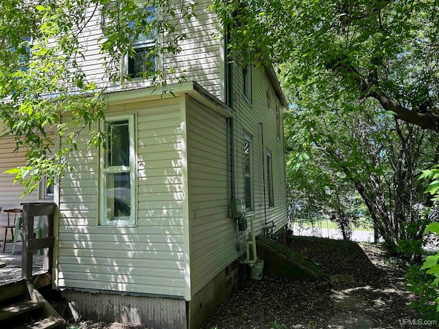 view of property exterior featuring a wooden deck