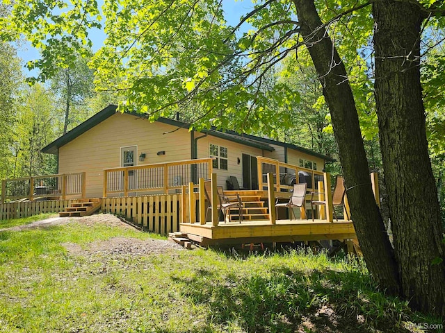 back of property featuring a wooden deck