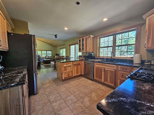 kitchen with stainless steel dishwasher, light tile floors, sink, lofted ceiling, and refrigerator