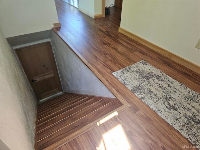 stairway with dark hardwood / wood-style floors