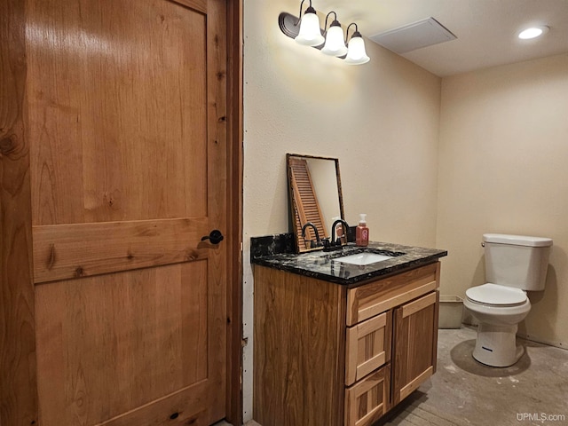 bathroom featuring toilet and large vanity