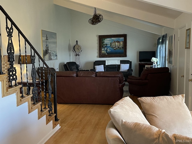 living room with lofted ceiling with beams and light wood-type flooring