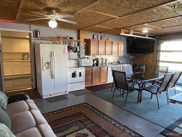 kitchen with ceiling fan, sink, backsplash, concrete floors, and white appliances