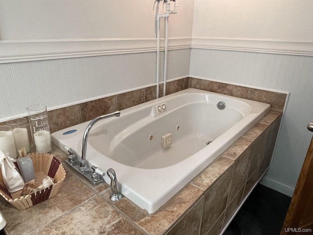 bathroom featuring tile patterned flooring and a relaxing tiled tub