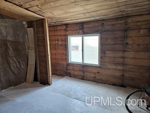 empty room featuring wooden ceiling