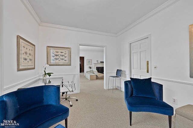 sitting room featuring carpet and crown molding