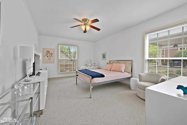 carpeted bedroom with ceiling fan and crown molding