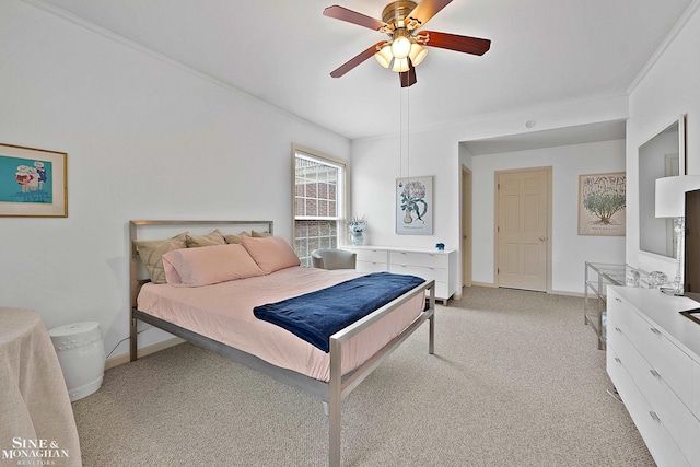 bedroom with light carpet, ceiling fan, and crown molding