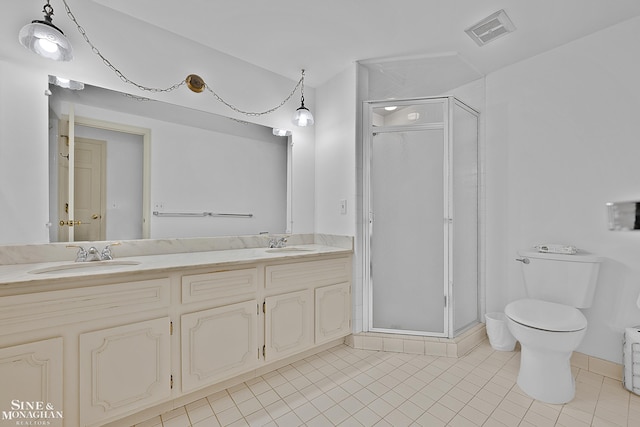 bathroom with tile patterned flooring, vanity, toilet, and walk in shower