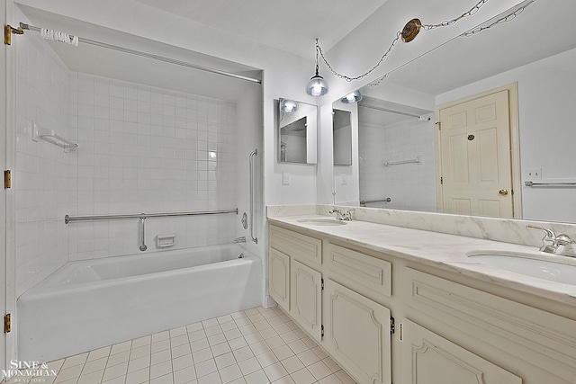 bathroom featuring tile patterned flooring, tiled shower / bath combo, and vanity