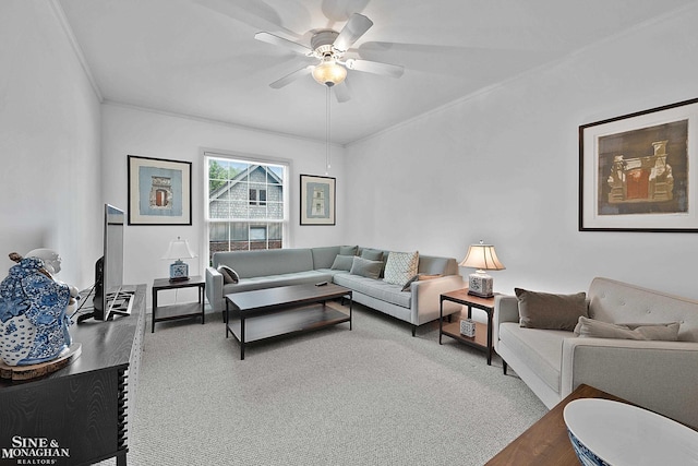 carpeted living room featuring crown molding and ceiling fan