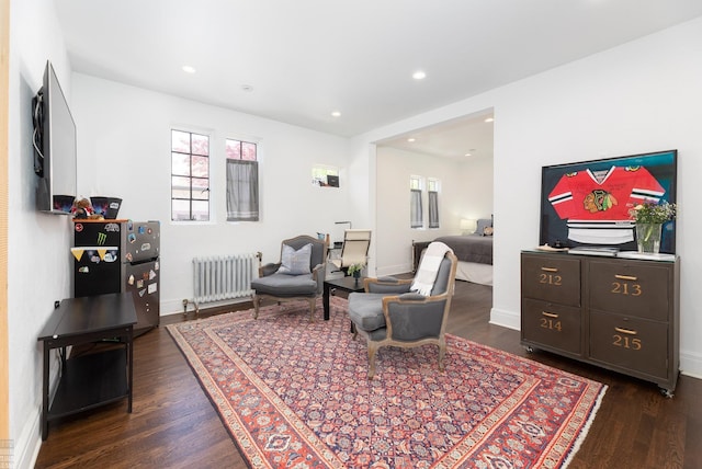 living room with baseboards, dark wood-type flooring, recessed lighting, and radiator