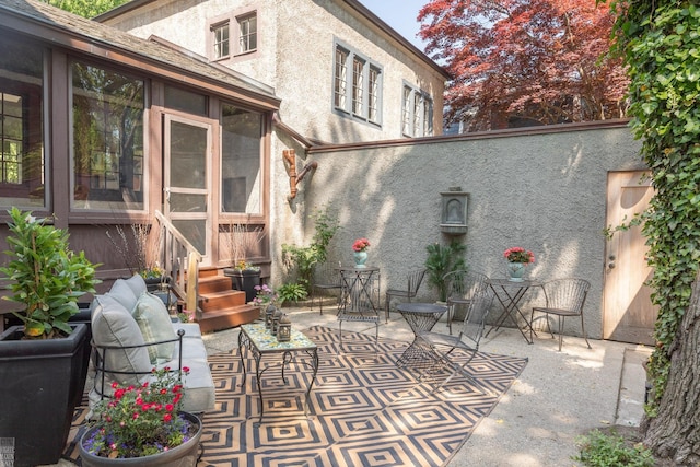 view of patio / terrace featuring a sunroom