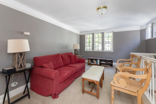 living room featuring light carpet and baseboards