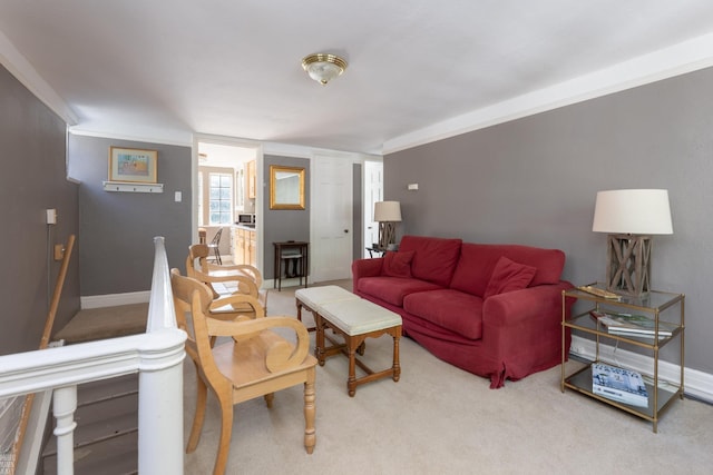 living area with light carpet and baseboards