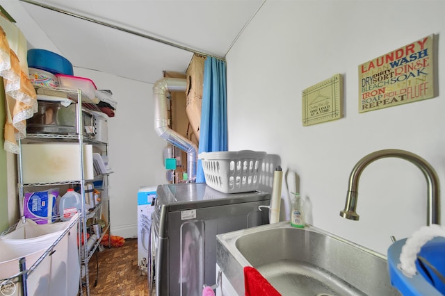 laundry area with washer and dryer, dark hardwood / wood-style flooring, and sink