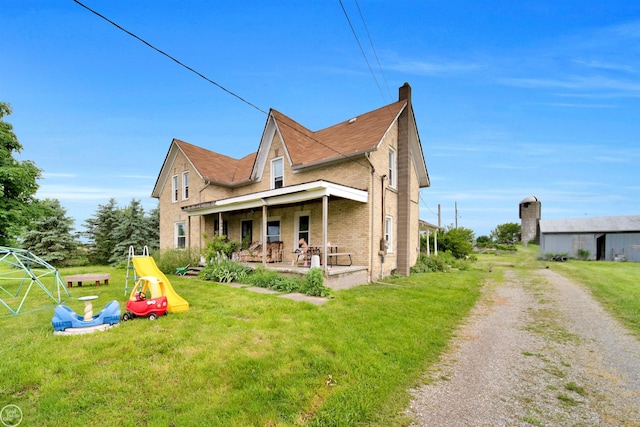 exterior space with a porch and a yard