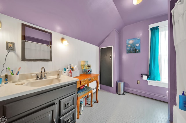 bathroom featuring tile patterned flooring, vanity, lofted ceiling, and a baseboard radiator