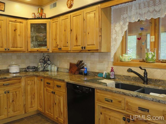 kitchen featuring stone countertops, black dishwasher, visible vents, and decorative backsplash