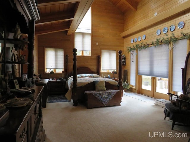 carpeted bedroom with french doors, vaulted ceiling with beams, and wooden walls