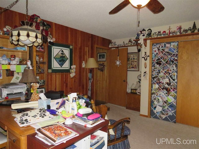 carpeted dining space with ceiling fan and wooden walls