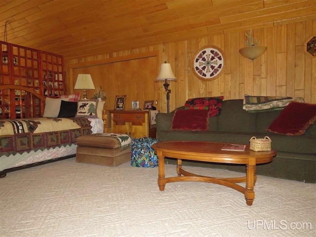 bedroom featuring carpet flooring, wood ceiling, and wooden walls