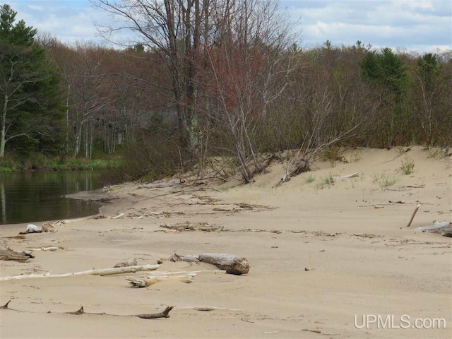 view of landscape with a water view and a wooded view