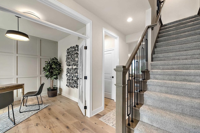 stairs featuring hardwood / wood-style flooring