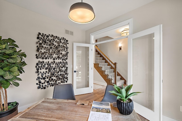 foyer entrance with french doors and hardwood / wood-style flooring