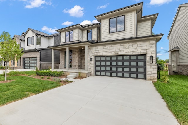 view of front of house featuring a garage and a front lawn